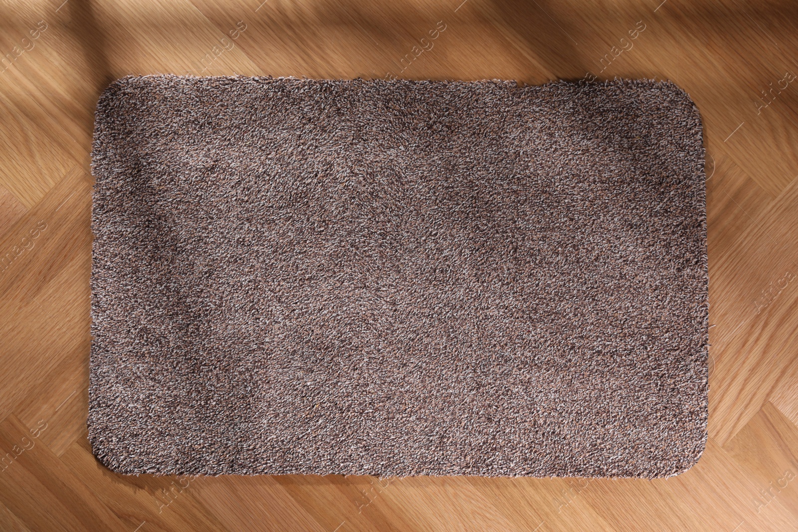 Photo of Stylish door mat on floor, top view