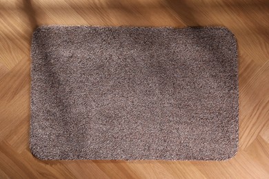 Stylish door mat on floor, top view