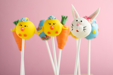 Delicious sweet cake pops on light pink background. Easter holiday