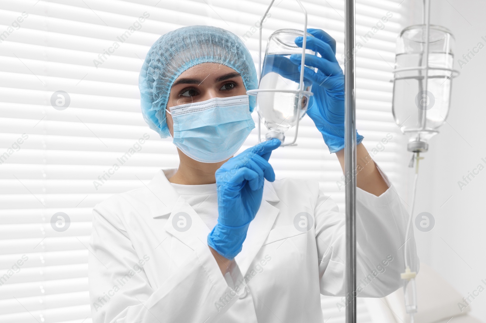 Photo of Nurse setting up IV drip in hospital