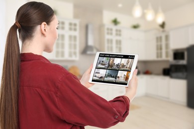 Image of Woman using smart home security system on tablet computer indoors. Device showing different rooms through cameras