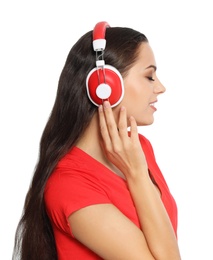 Young woman listening to Christmas music on white background