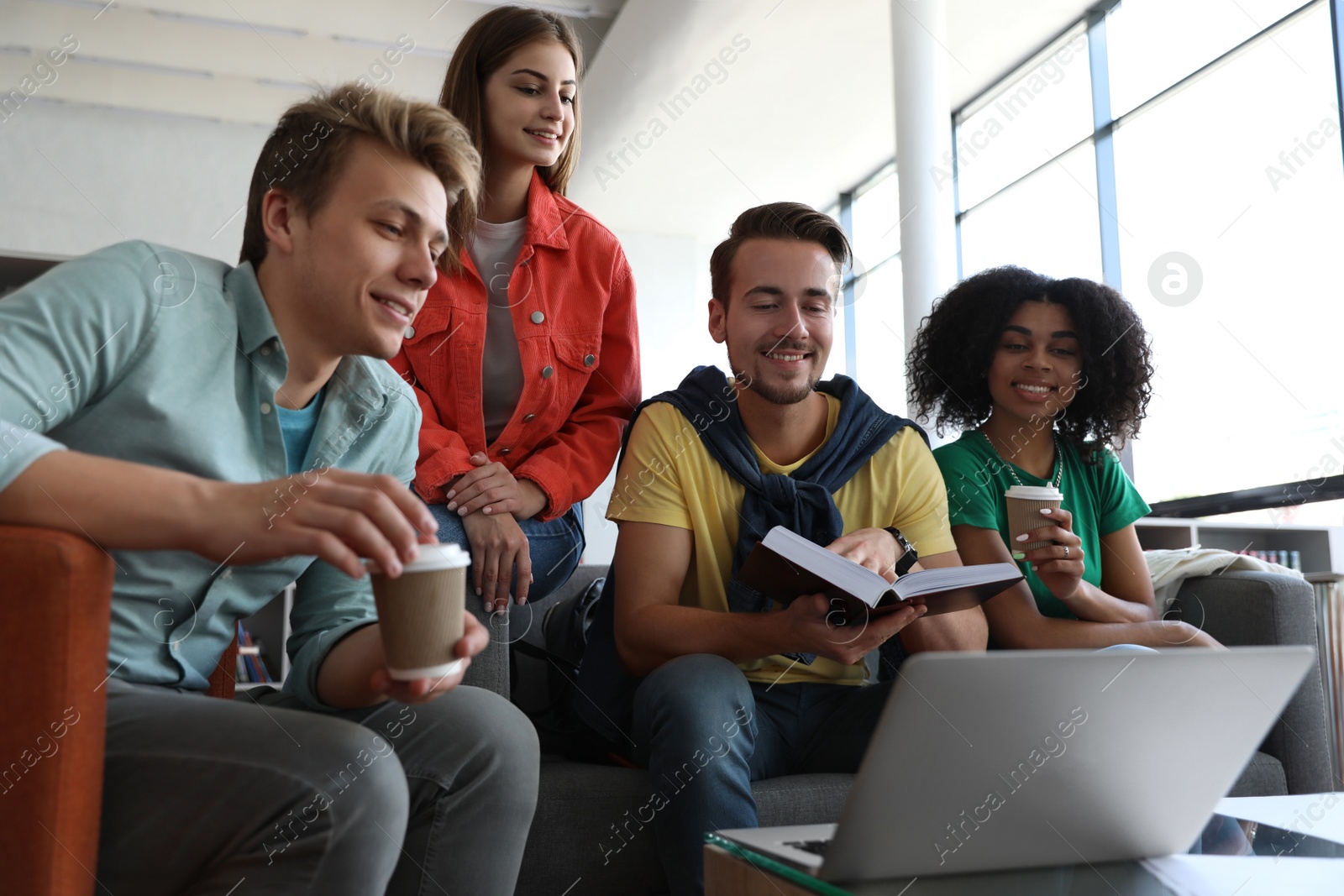 Photo of Group of young people studying at table in library