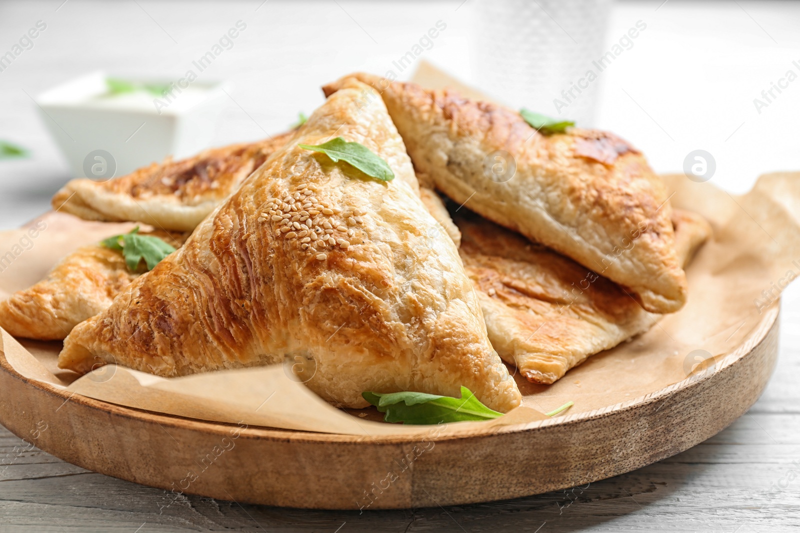 Photo of Fresh delicious puff pastry on white wooden table, closeup