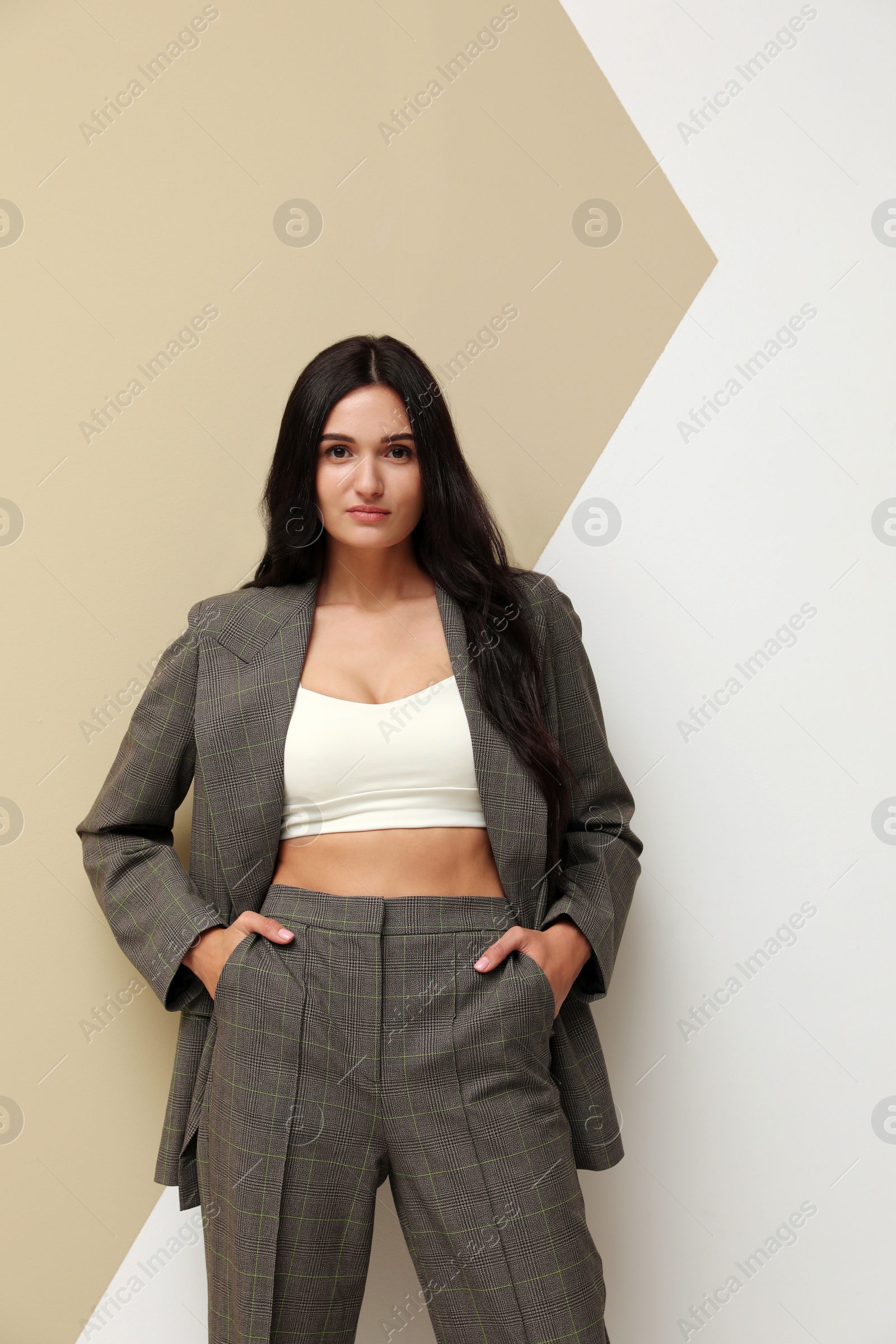 Photo of Beautiful woman in formal suit on color background. Business attire