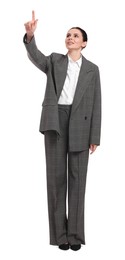 Photo of Beautiful businesswoman in suit pointing at something on white background