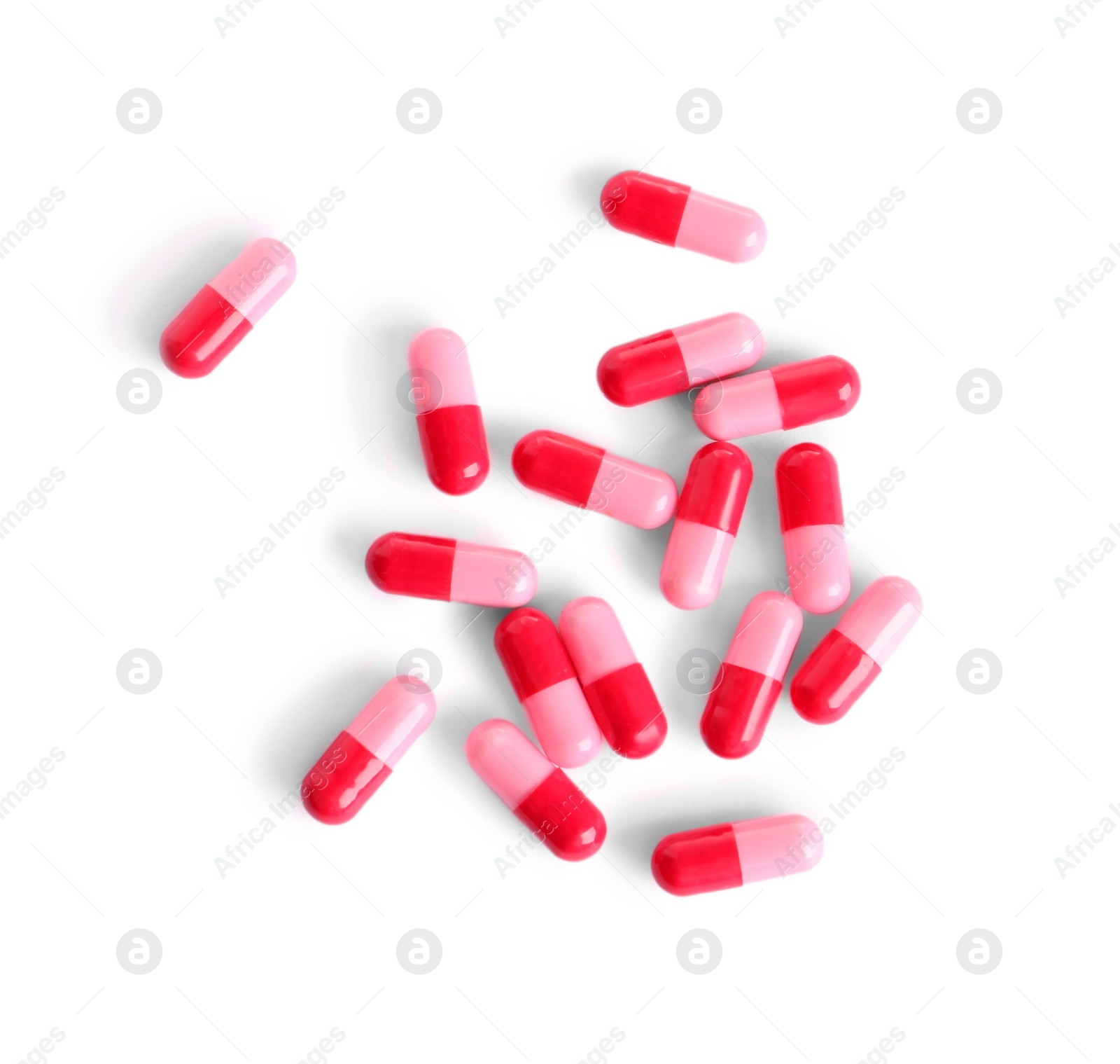 Photo of Many pink pills isolated on white, top view