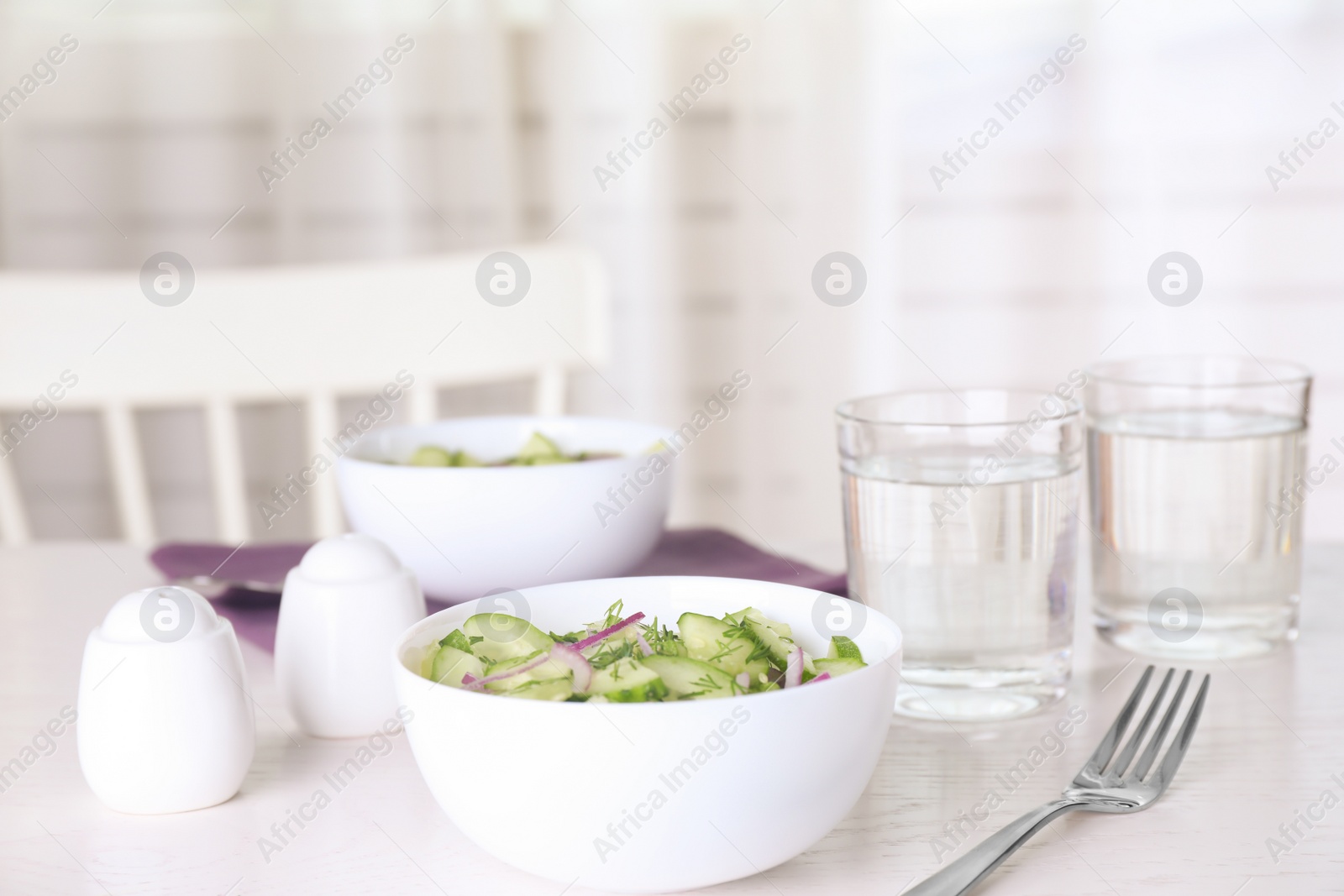 Photo of Delicious fresh cucumber onion salad served on table