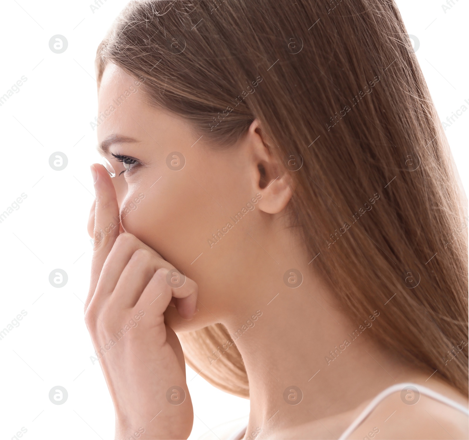 Photo of Young woman putting contact lens on white background