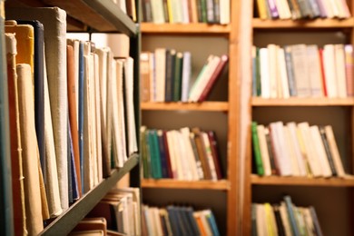 Collection of different books on shelves in library