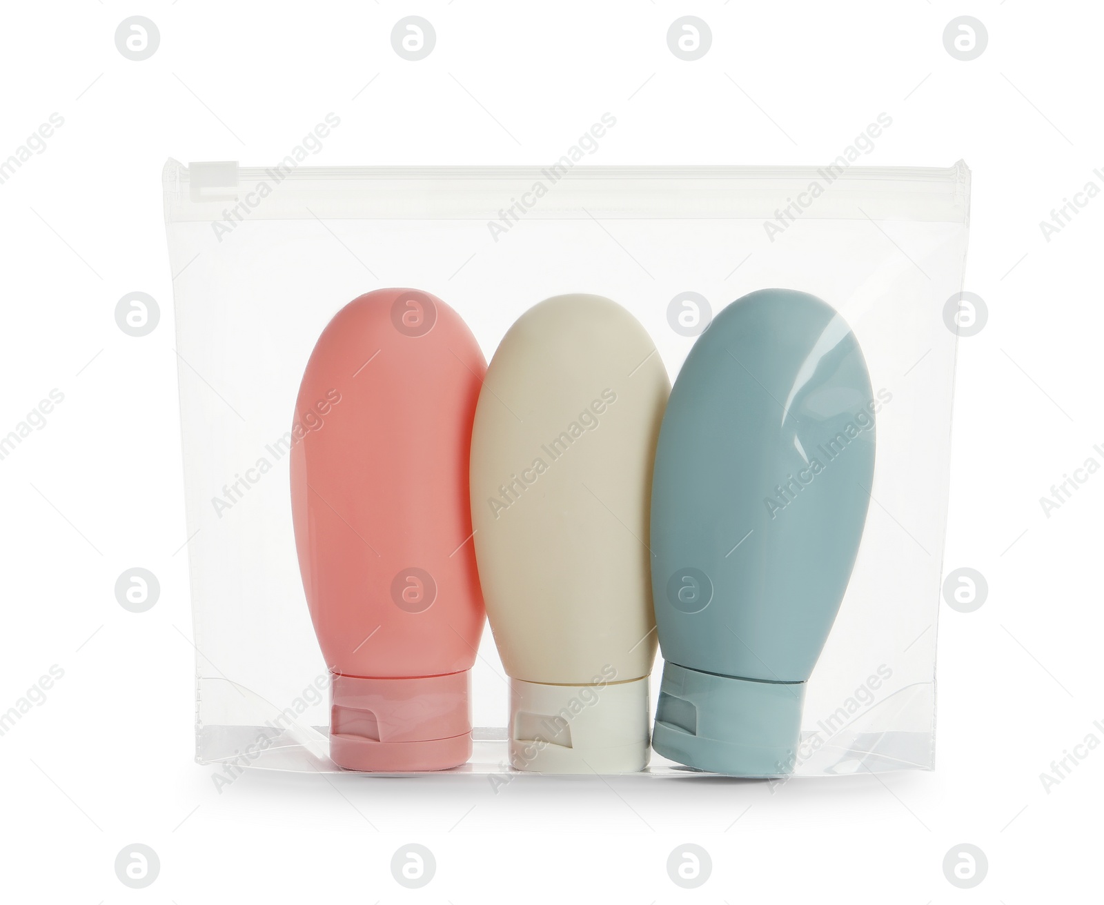 Photo of Cosmetic travel kit with plastic bag isolated on white