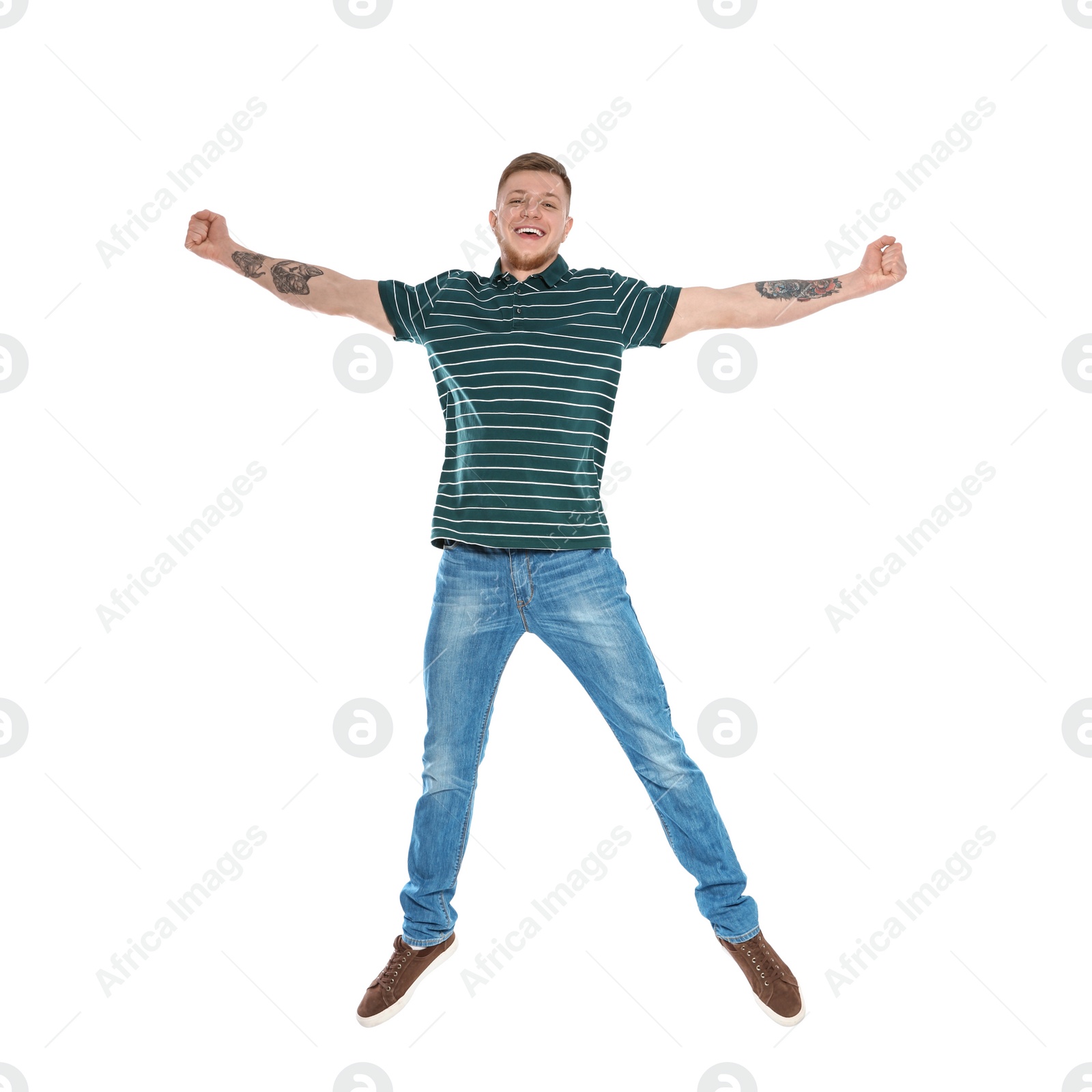 Photo of Handsome young man jumping on white background