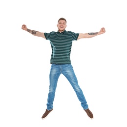 Photo of Handsome young man jumping on white background