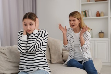 Photo of Mother scolding her teenage daughter at home