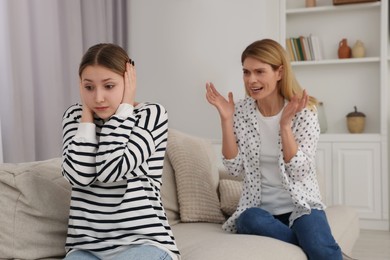 Mother scolding her teenage daughter at home