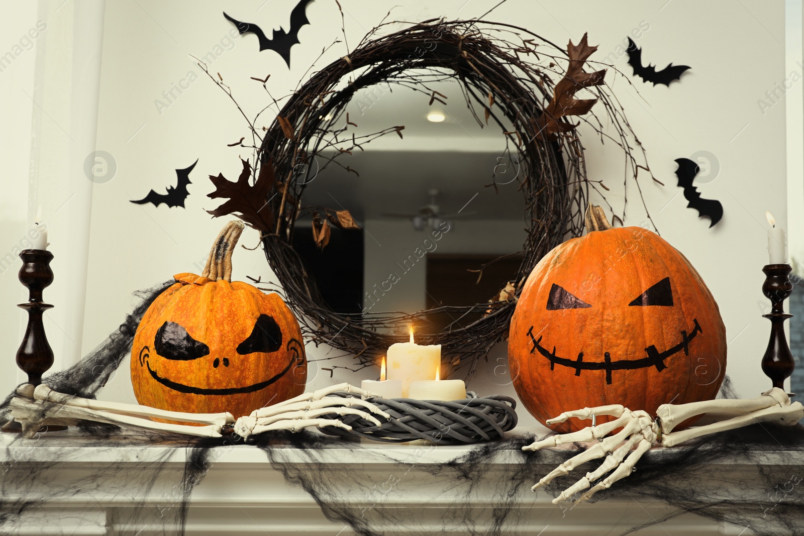 Photo of Different Halloween decor on mantelpiece indoors. Festive interior