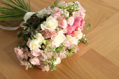 Photo of Beautiful bouquet of fresh flowers on wooden table, space for text