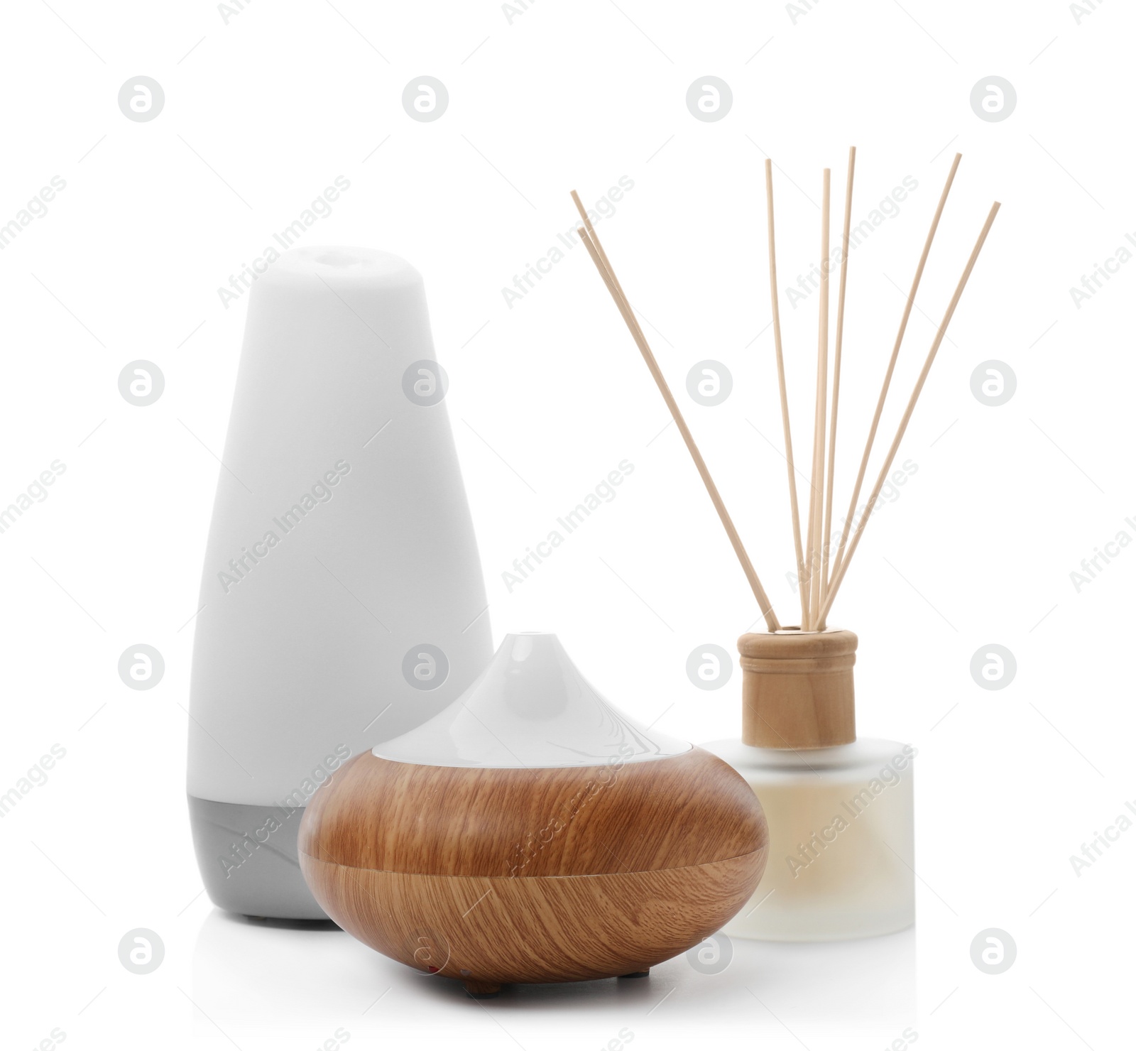 Photo of Different aroma oil diffusers on white background. Air freshening