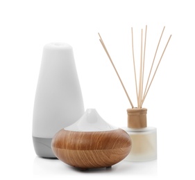 Photo of Different aroma oil diffusers on white background. Air freshening