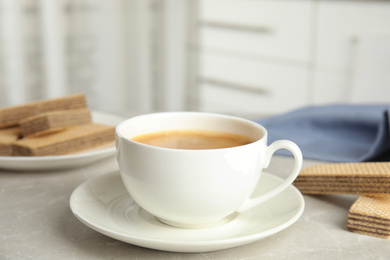 Delicious coffee and wafers for breakfast on grey marble table