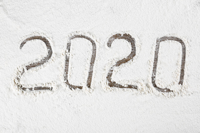 Photo of Number 2020 made with flour on wooden table, top view