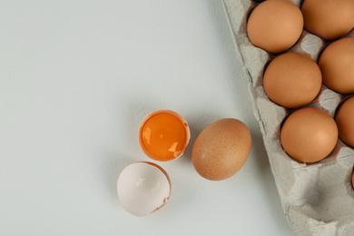 Photo of Raw chicken eggs on white table, flat lay