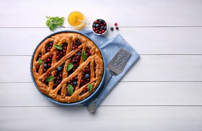 Delicious currant pie, honey and fresh berries on white wooden table, flat lay. Space for text