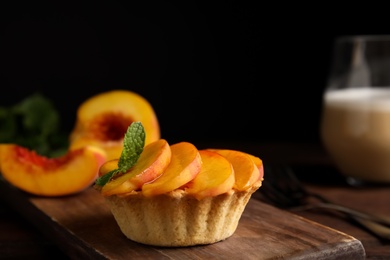 Photo of Delicious peach dessert on wooden table, closeup