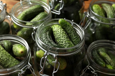 Photo of Pickling jars with fresh cucumbers, closeup view