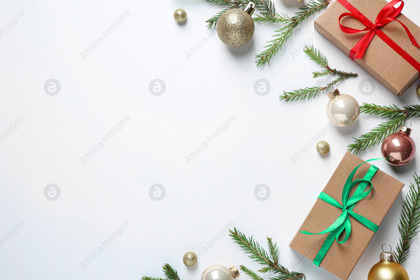 Photo of Flat lay composition with Christmas gifts and festive decor on white background. Space for text