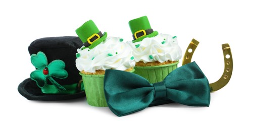 St. Patrick's day party. Tasty festively decorated cupcakes, green bow tie, gold horseshoe and leprechaun hat, isolated on white