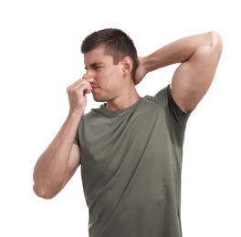 Young man with sweat stain on his clothes against white background. Using deodorant