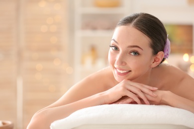 Photo of Beautiful young woman on massage table in spa salon