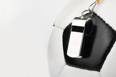 Photo of Football referee equipment. Soccer ball and whistle on white background