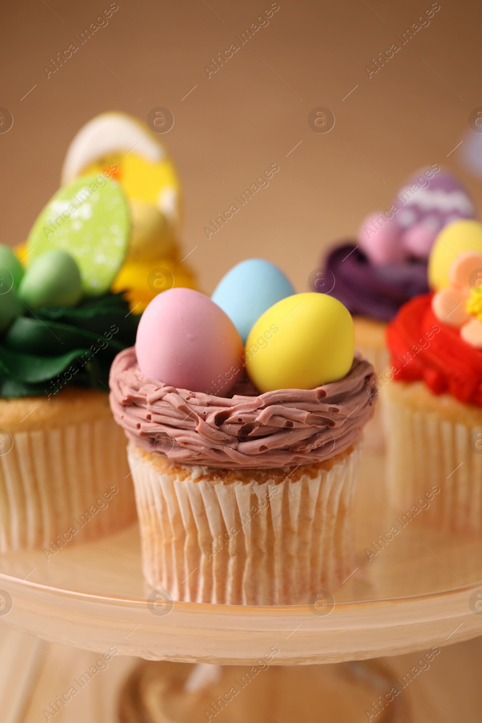 Photo of Tasty cupcakes with Easter decor on stand, closeup