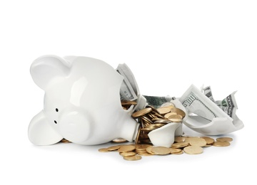 Broken piggy bank with money isolated on white