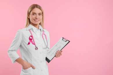 Photo of Doctor with pink ribbon, clipboard and stethoscope on color background, space for text. Breast cancer awareness
