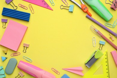 Photo of Flat lay composition with different school stationery on pale yellow background, space for text. Back to school