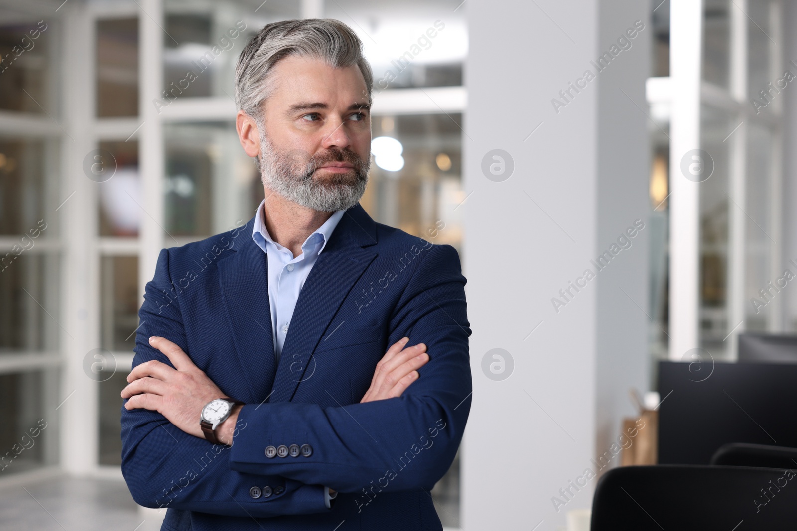 Photo of Portrait of handsome man with crossed arms in office, space for text. Lawyer, businessman, accountant or manager