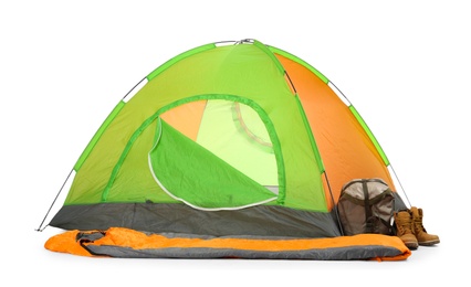 Photo of Comfortable colorful camping tent with sleeping bag and boots on white background