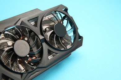 Photo of One graphics card on light blue background, closeup. Space for text