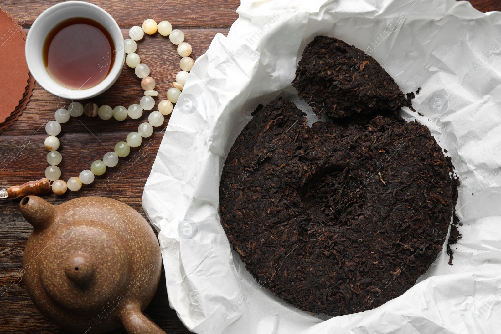 Photo of Flat lay composition with pu-erh tea on wooden table