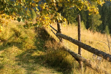 Photo of Wooden fence in countryside on sunny day