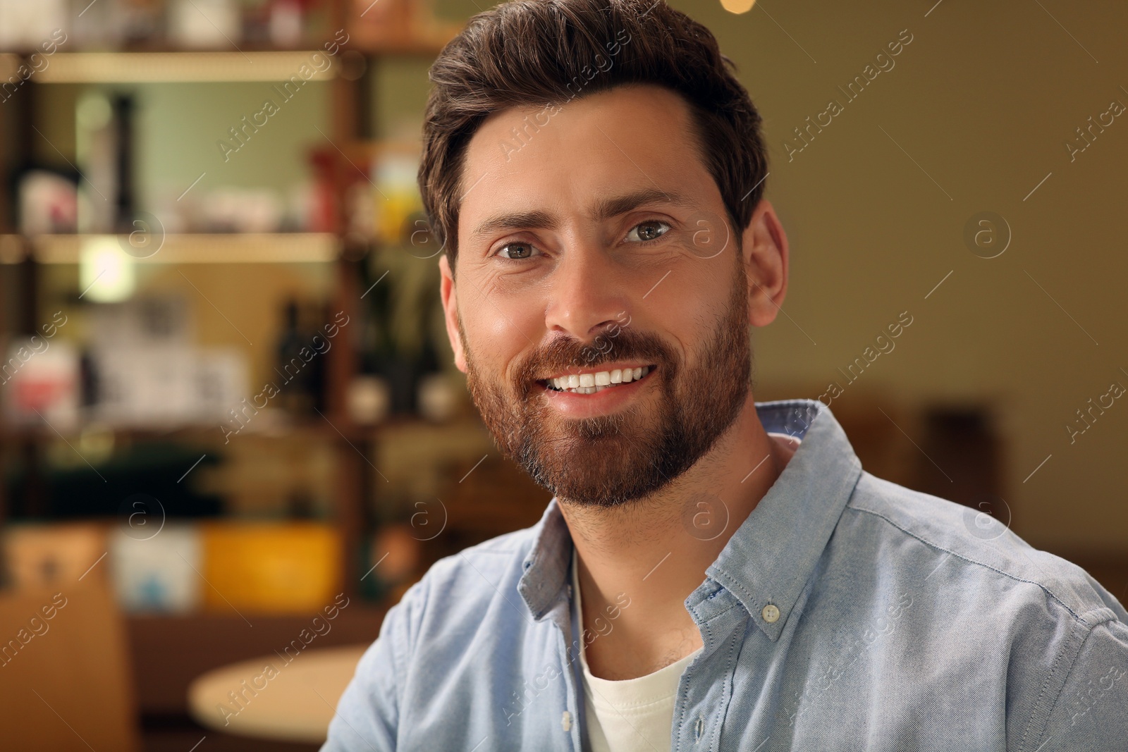 Photo of Portrait of handsome stylish man in cafe