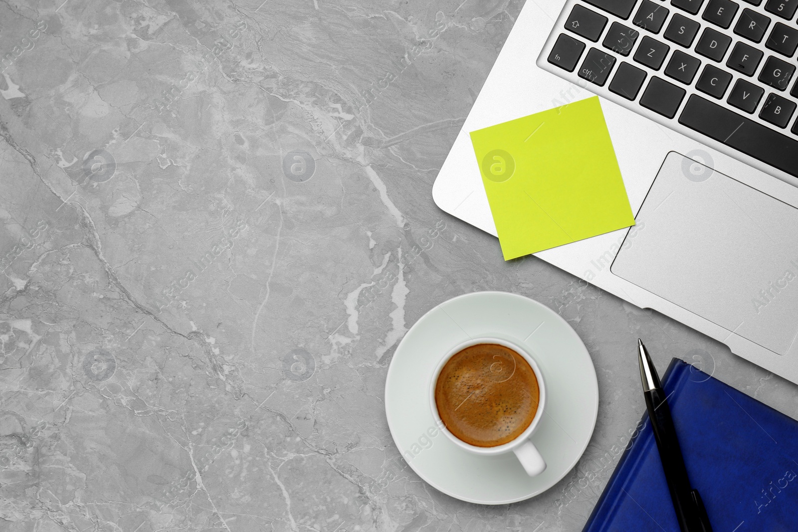 Photo of Laptop with blank sticky note, notebook, pen and cup of coffee on grey table, flat lay. Space for text