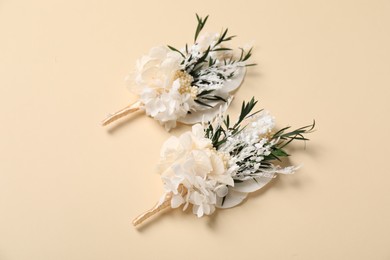 Stylish boutonniere on beige background, above view