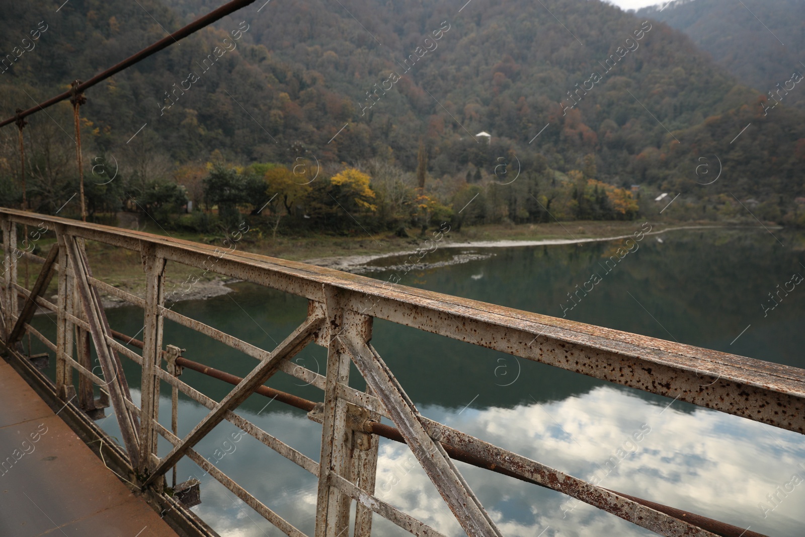 Photo of Picturesque view of metal bridge over river in mountains