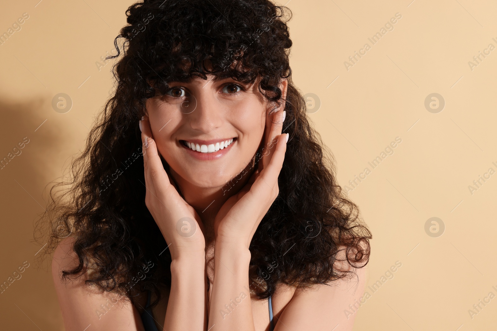 Photo of Portrait of beautiful young woman on beige background