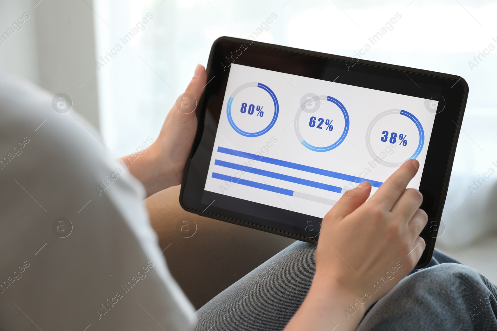 Photo of Woman working with tablet at home, closeup