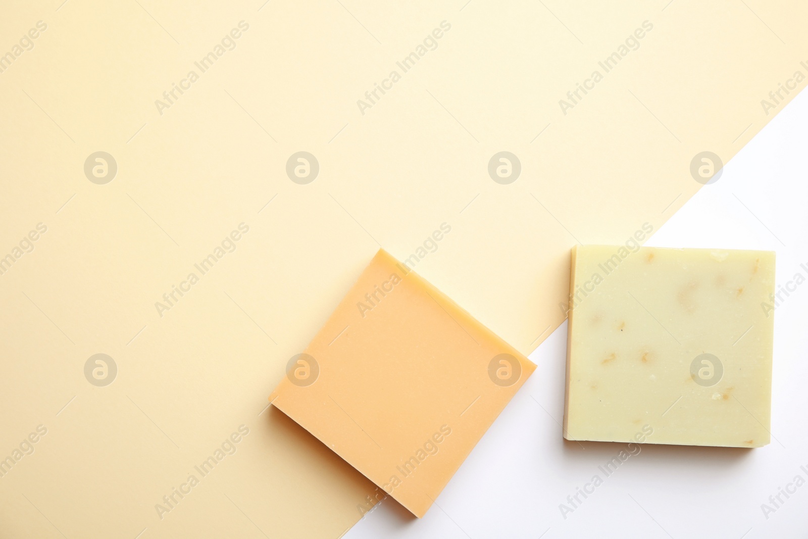 Photo of Hand made soap bars on color background, top view. Space for text
